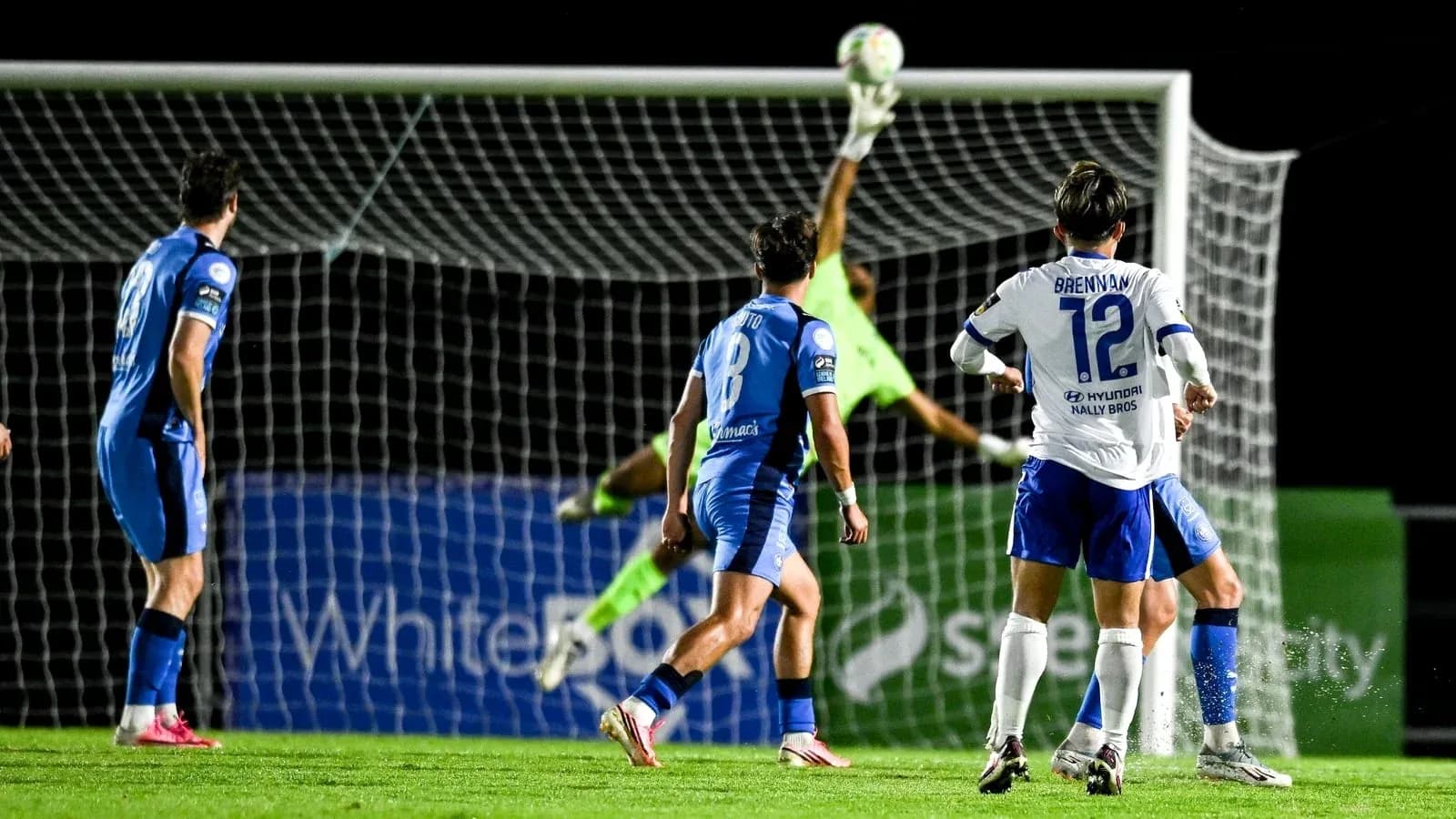 Goalkeeper diving to save a shot on goal Goalkeeper diving to save a shot on goal