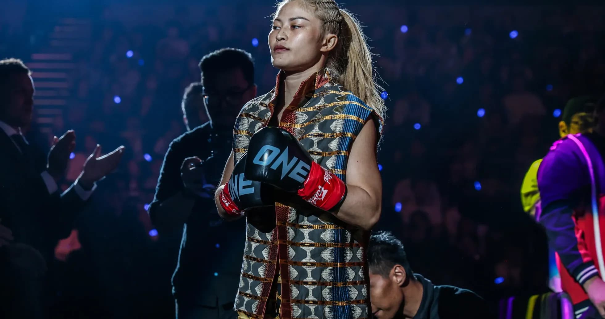Fighter entering the arena wearing gloves and traditional attire Fighter entering the arena wearing gloves and traditional attire