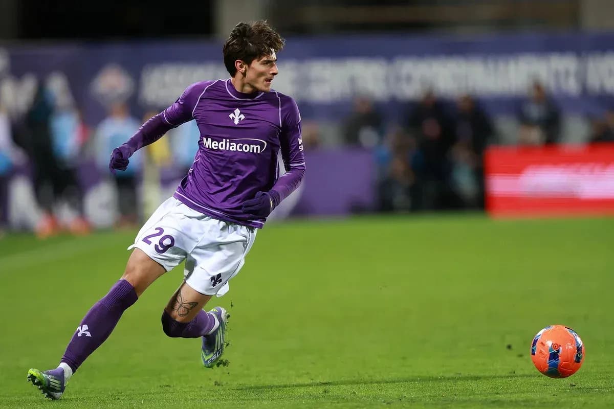 Fiorentina player running after the ball on field Fiorentina player running after the ball on field