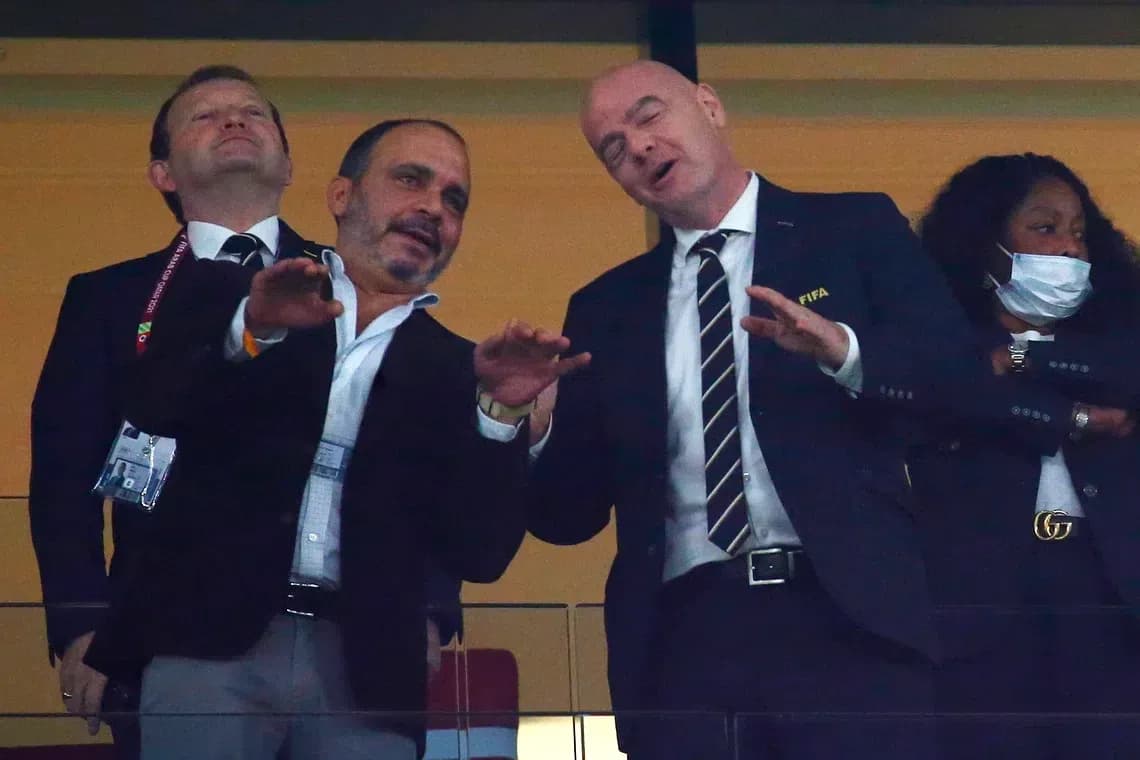 Officials interacting in a stadium box during event Officials interacting in a stadium box during event
