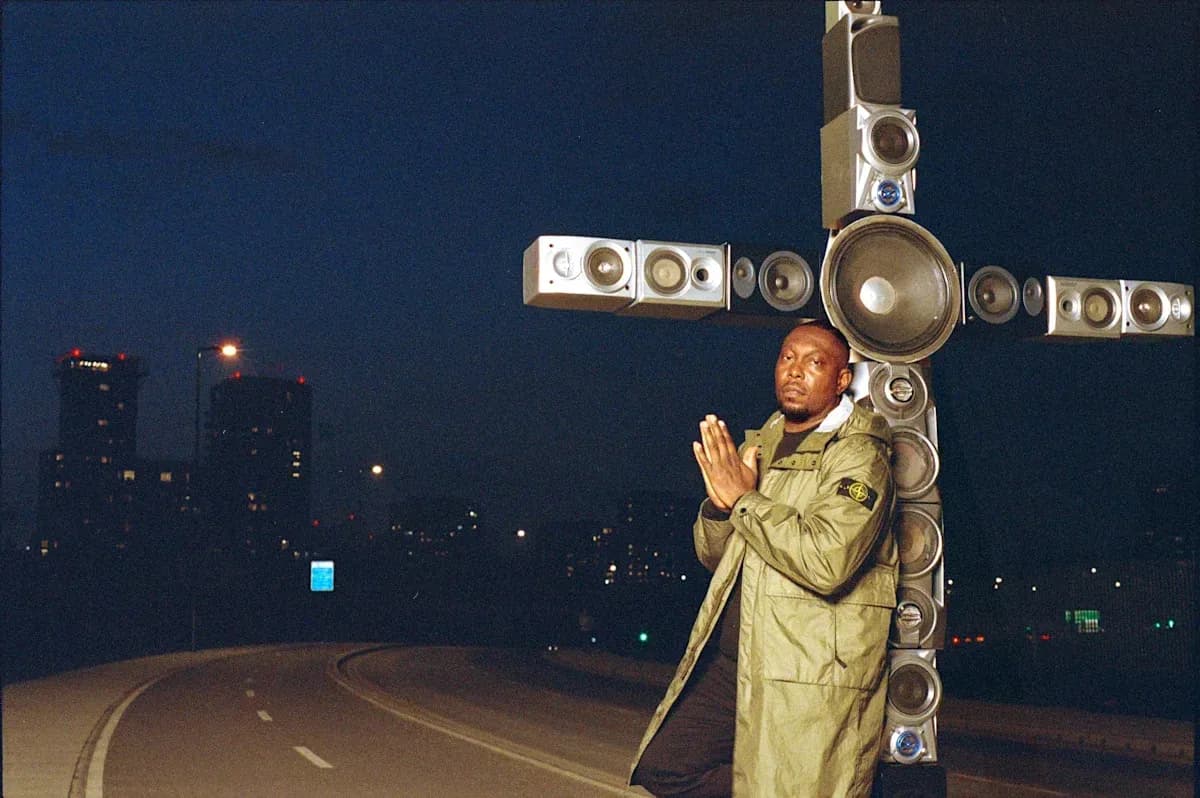 Man posing with large speakers at night Man posing with large speakers at night