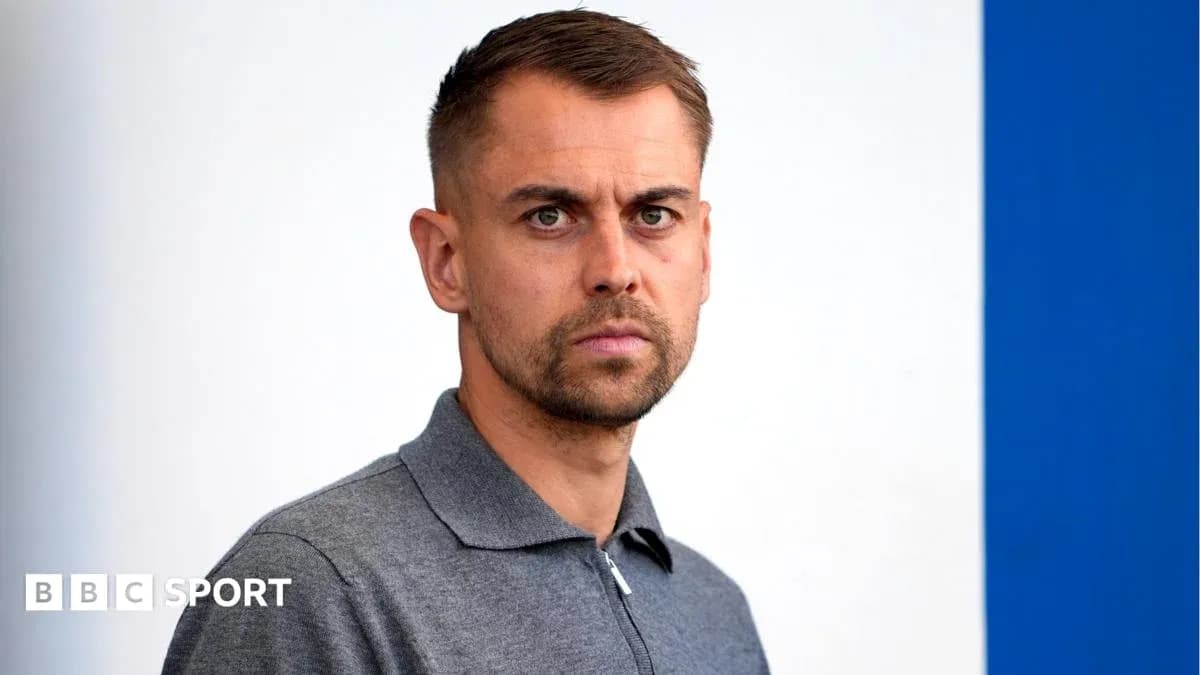 Men's football manager posing for photo Men's football manager posing for photo