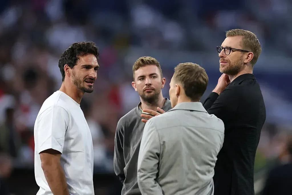 Four men conversing at a sports event Four men conversing at a sports event