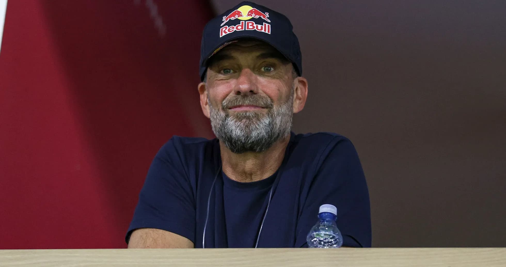 Man wearing Red Bull cap observing from balcony Man wearing Red Bull cap observing from balcony
