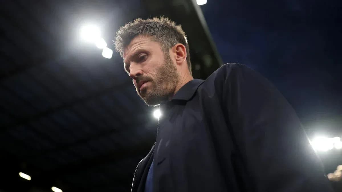 Football manager walking on the pitch at night Football manager walking on the pitch at night