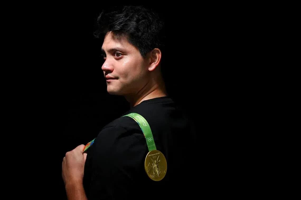 Athlete wearing Olympic gold medal on shoulder Athlete wearing Olympic gold medal on shoulder