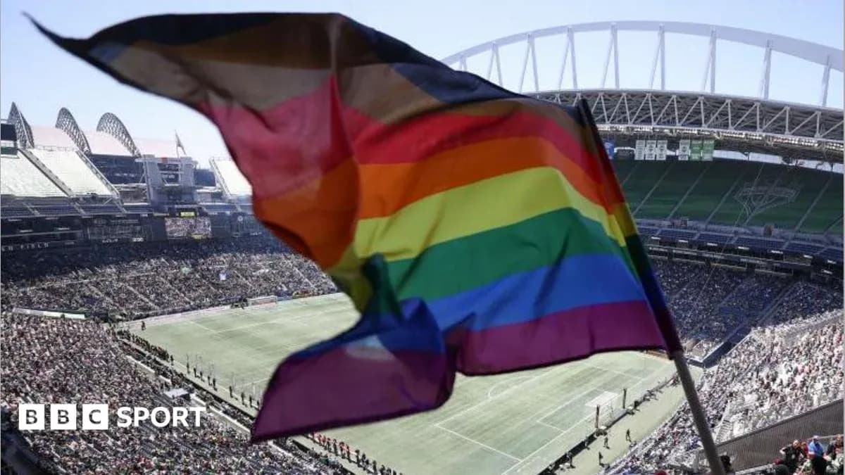 Rainbow flag waving in stadium during match Rainbow flag waving in stadium during match