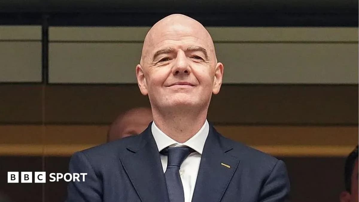Man in suit smiling at an event Man in suit smiling at an event
