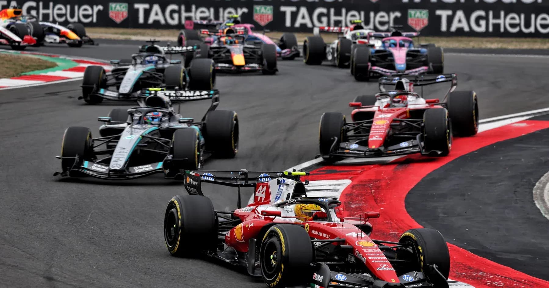 Formula 1 cars racing on track during competition Formula 1 cars racing on track during competition