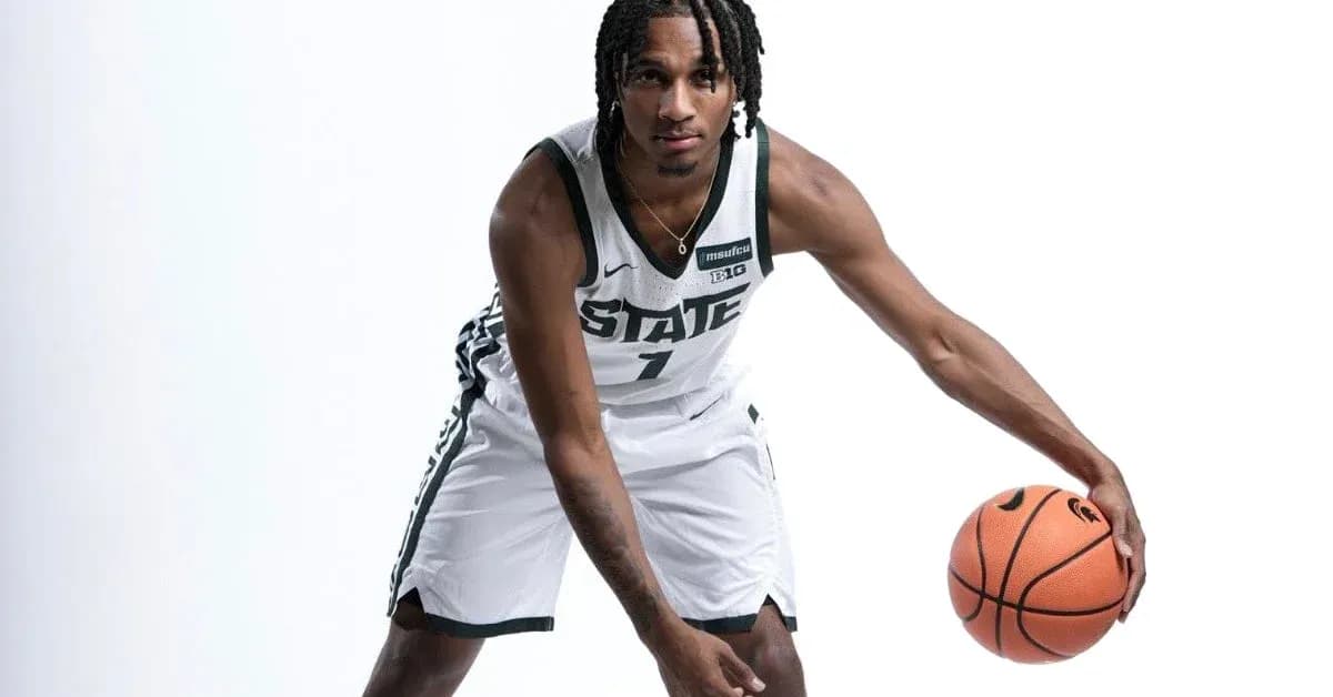 Basketball player posing with ball in uniform Basketball player posing with ball in uniform