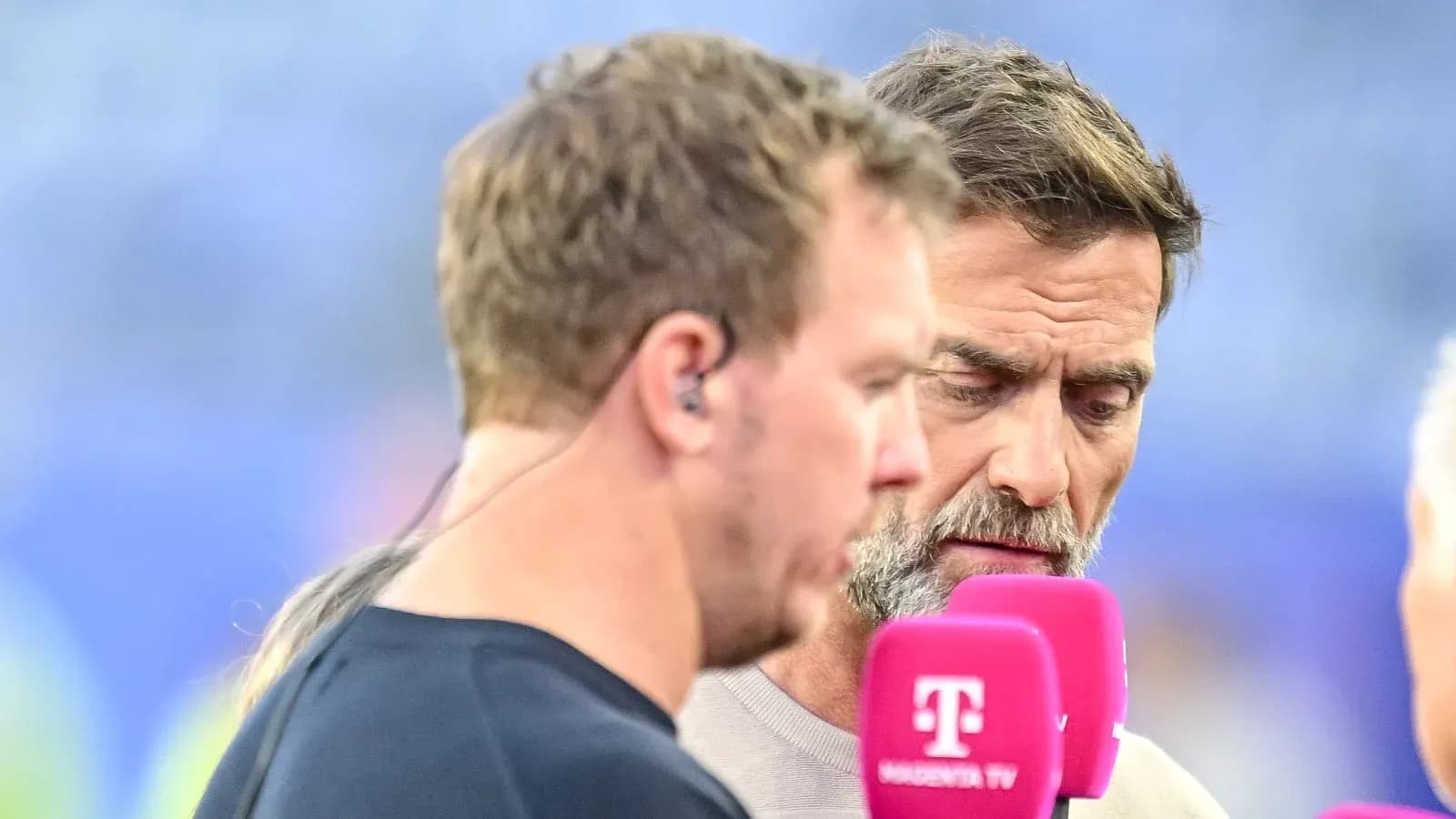 Duo discussing with microphones before match event Duo discussing with microphones before match event