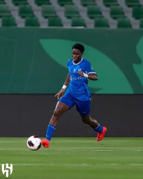 Futbolchi to'pni ushlagan holda yugurmoqda Futbolchi to'pni ushlagan holda yugurmoqda