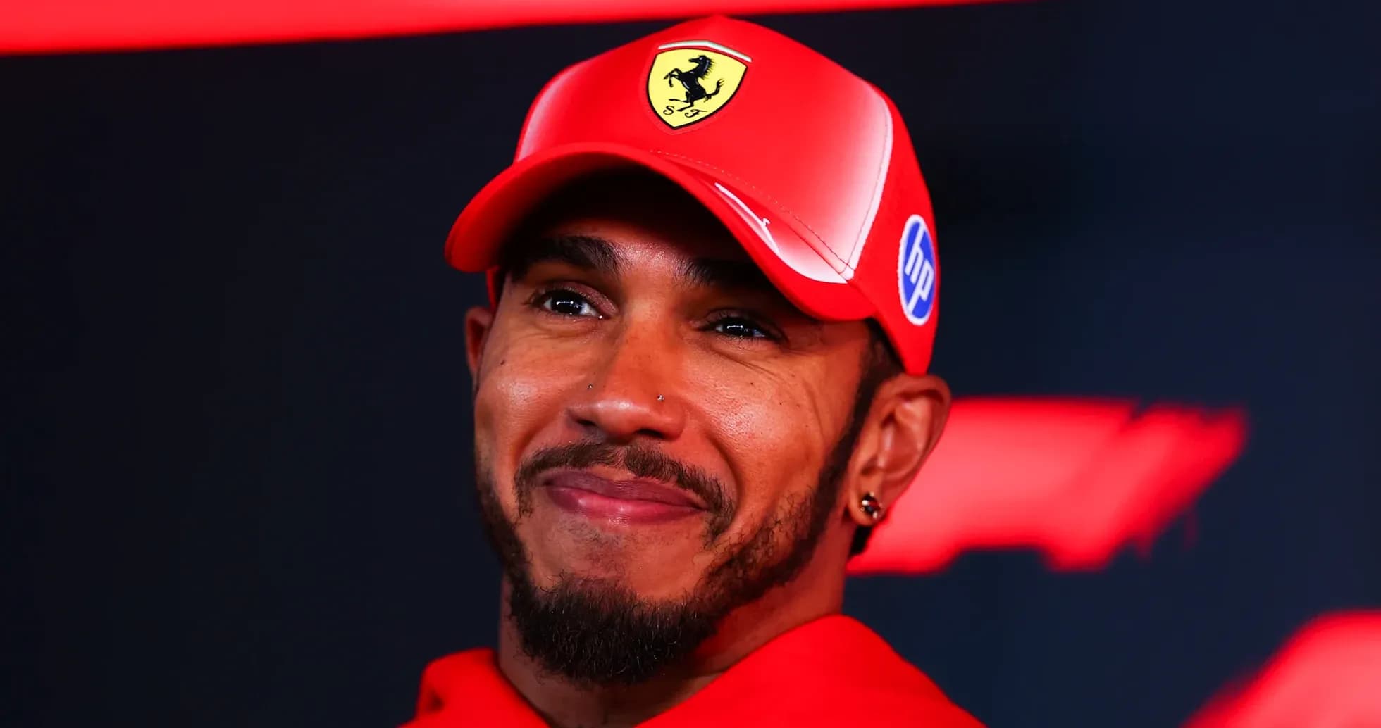 Driver wearing Ferrari cap at press event Driver wearing Ferrari cap at press event