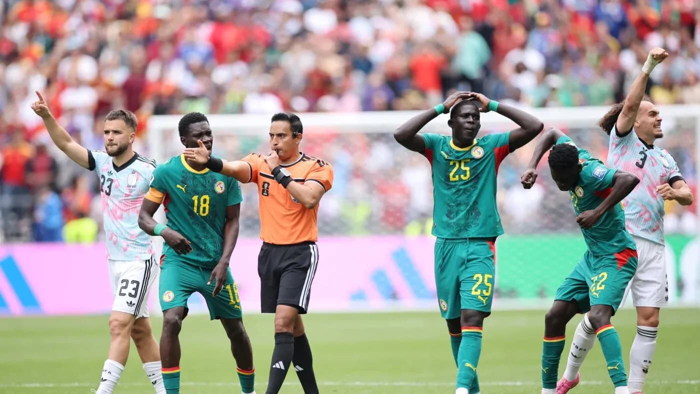 Referee signaling during Senegal match with players Referee signaling during Senegal match with players
