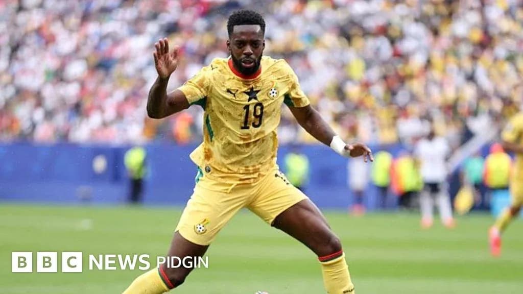 Ghana player in yellow kit during match action Ghana player in yellow kit during match action