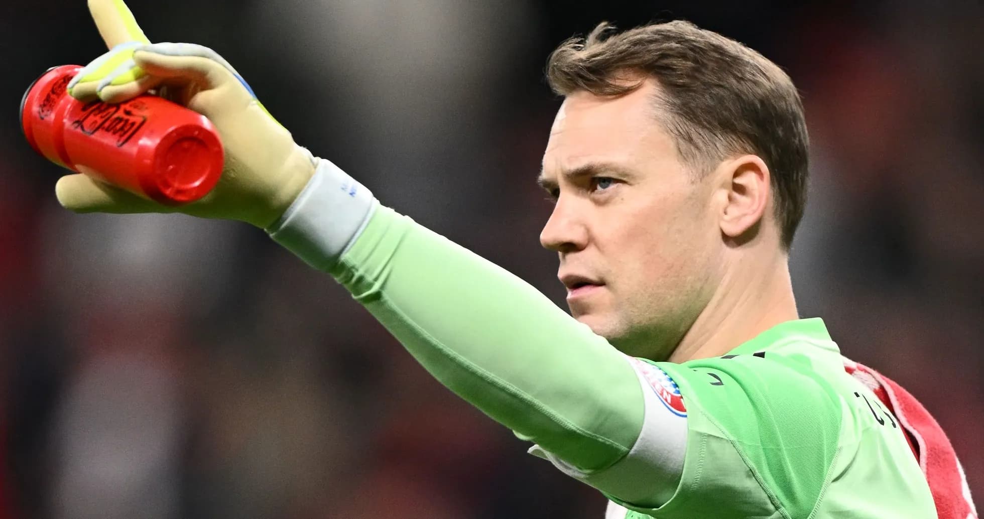 Goalkeeper holding a drink and signaling during match Goalkeeper holding a drink and signaling during match