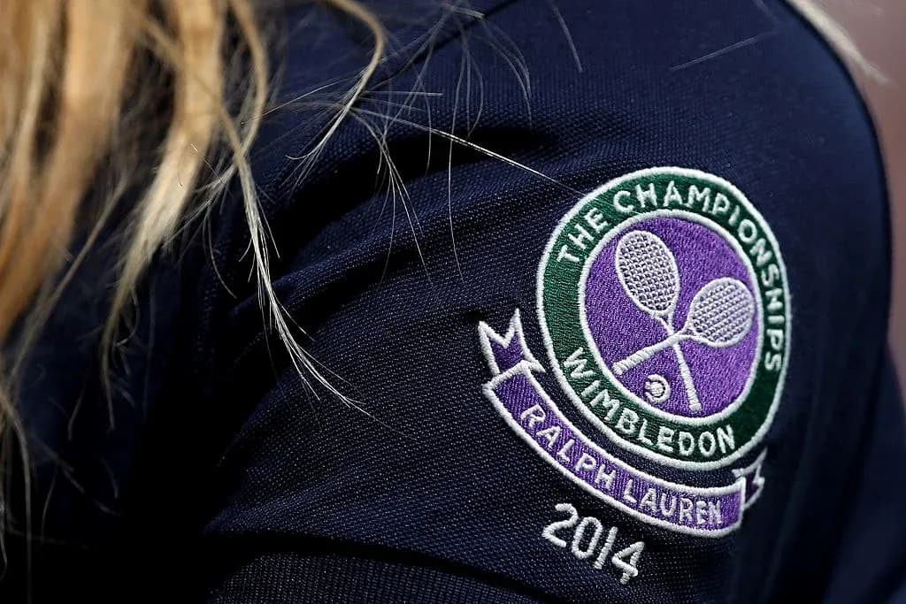 Wimbledon logo on a navy blue shirt sleeve Wimbledon logo on a navy blue shirt sleeve
