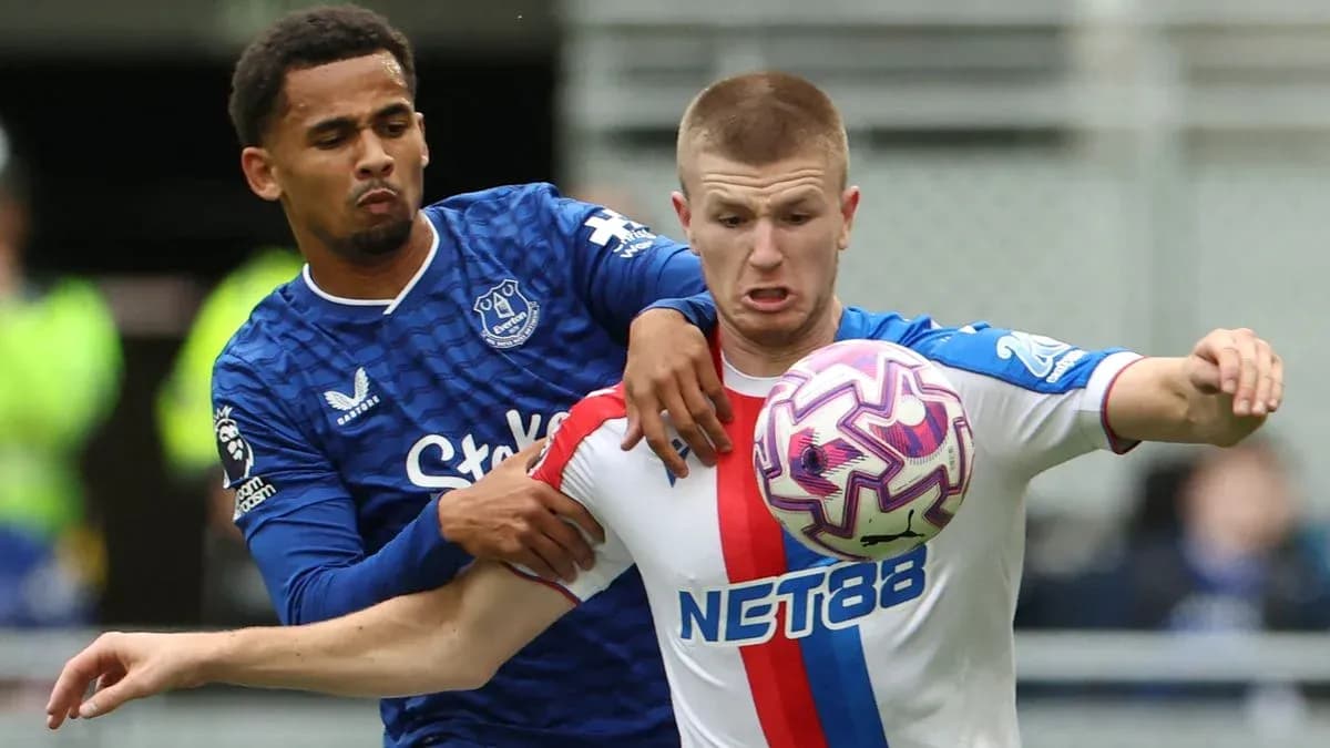 Everton player challenges for the ball against opponent Everton player challenges for the ball against opponent