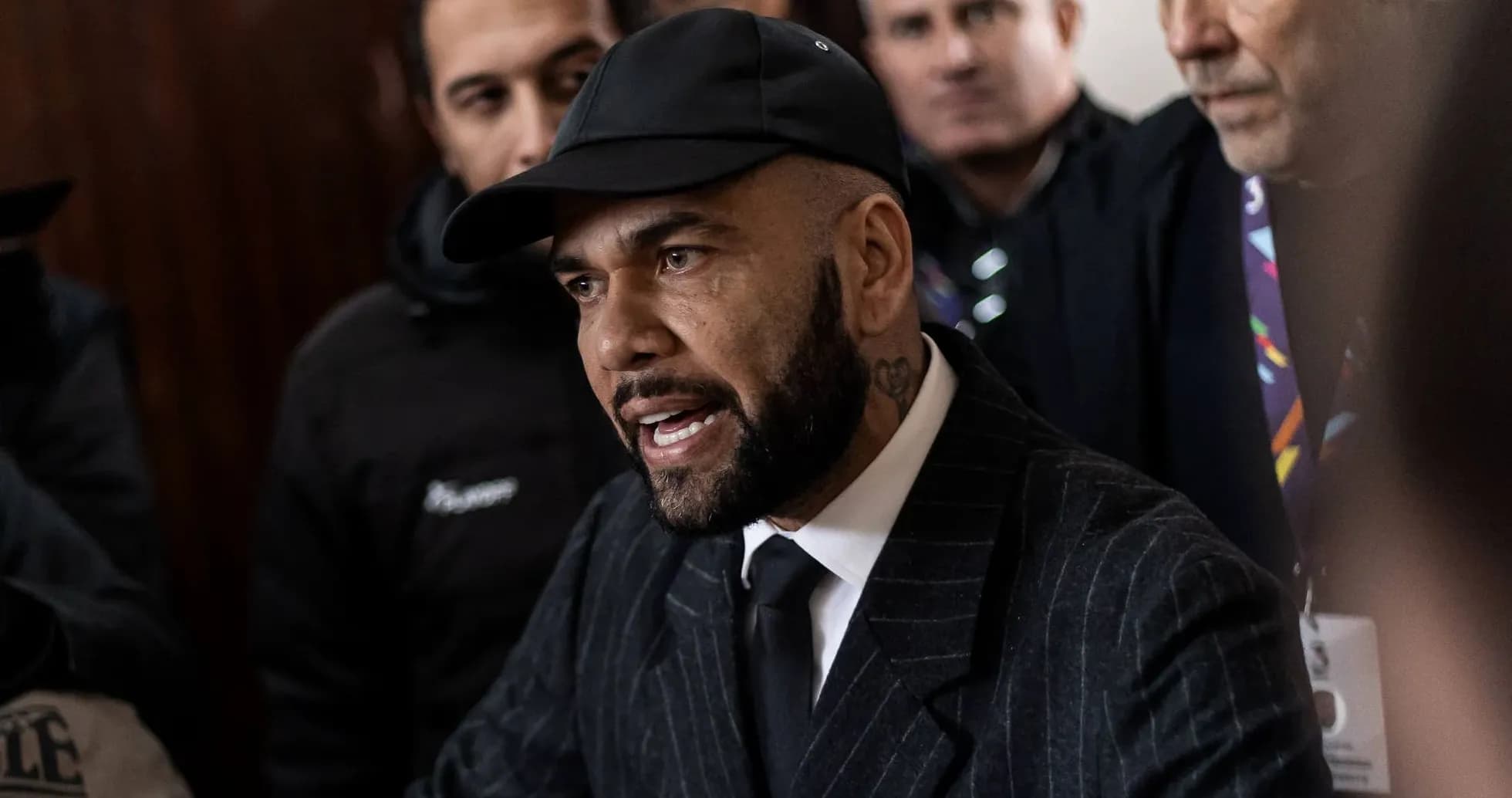 Shirted man speaking to reporters in a crowd Shirted man speaking to reporters in a crowd