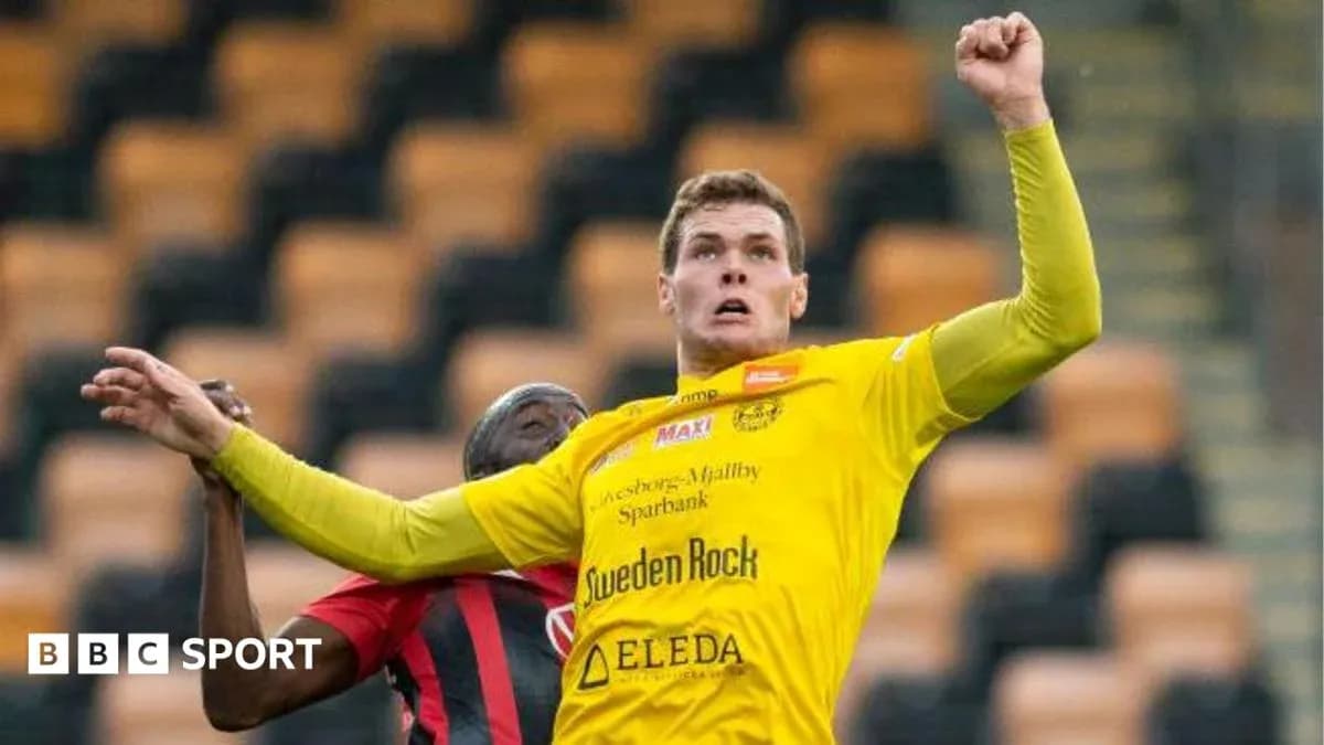 Player in yellow jersey jumping for a header Player in yellow jersey jumping for a header