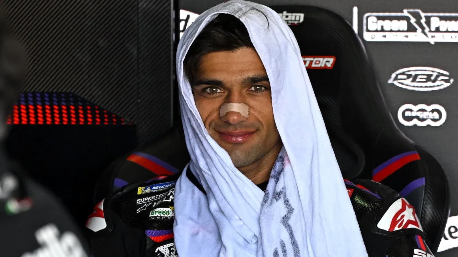 Motorsport athlete with towel and bandage on nose Motorsport athlete with towel and bandage on nose
