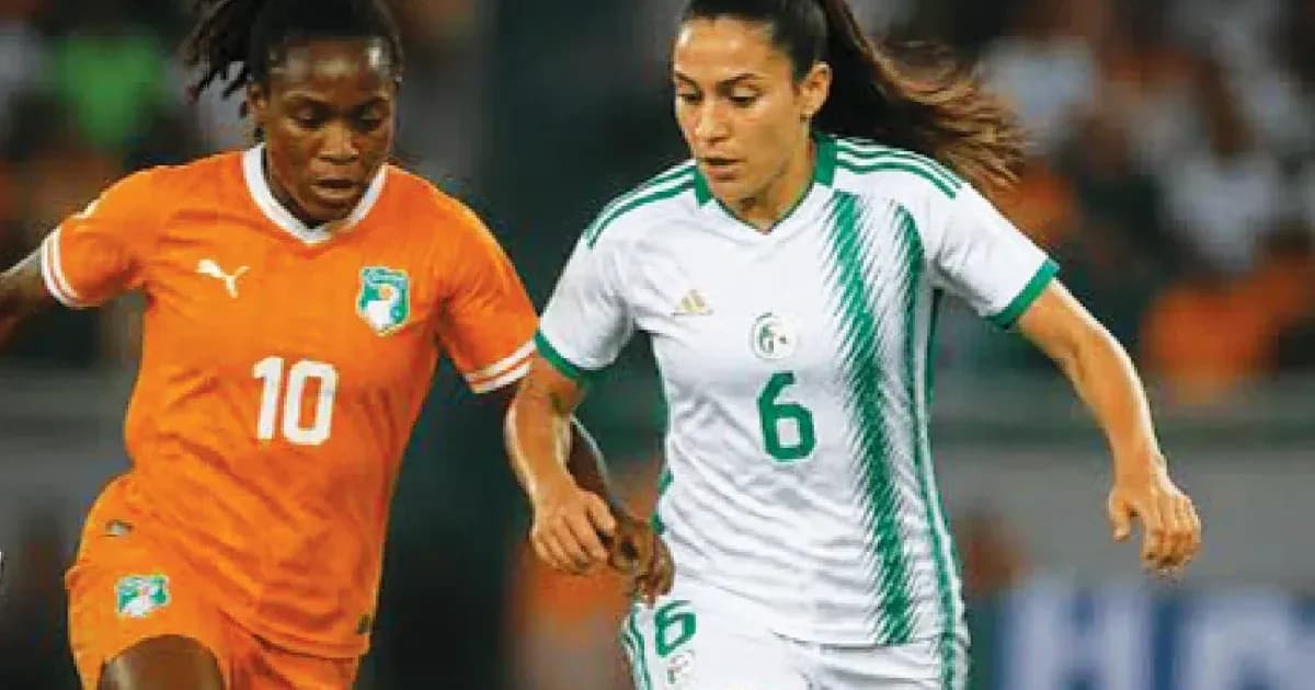 Two female football players competing for the ball Two female football players competing for the ball