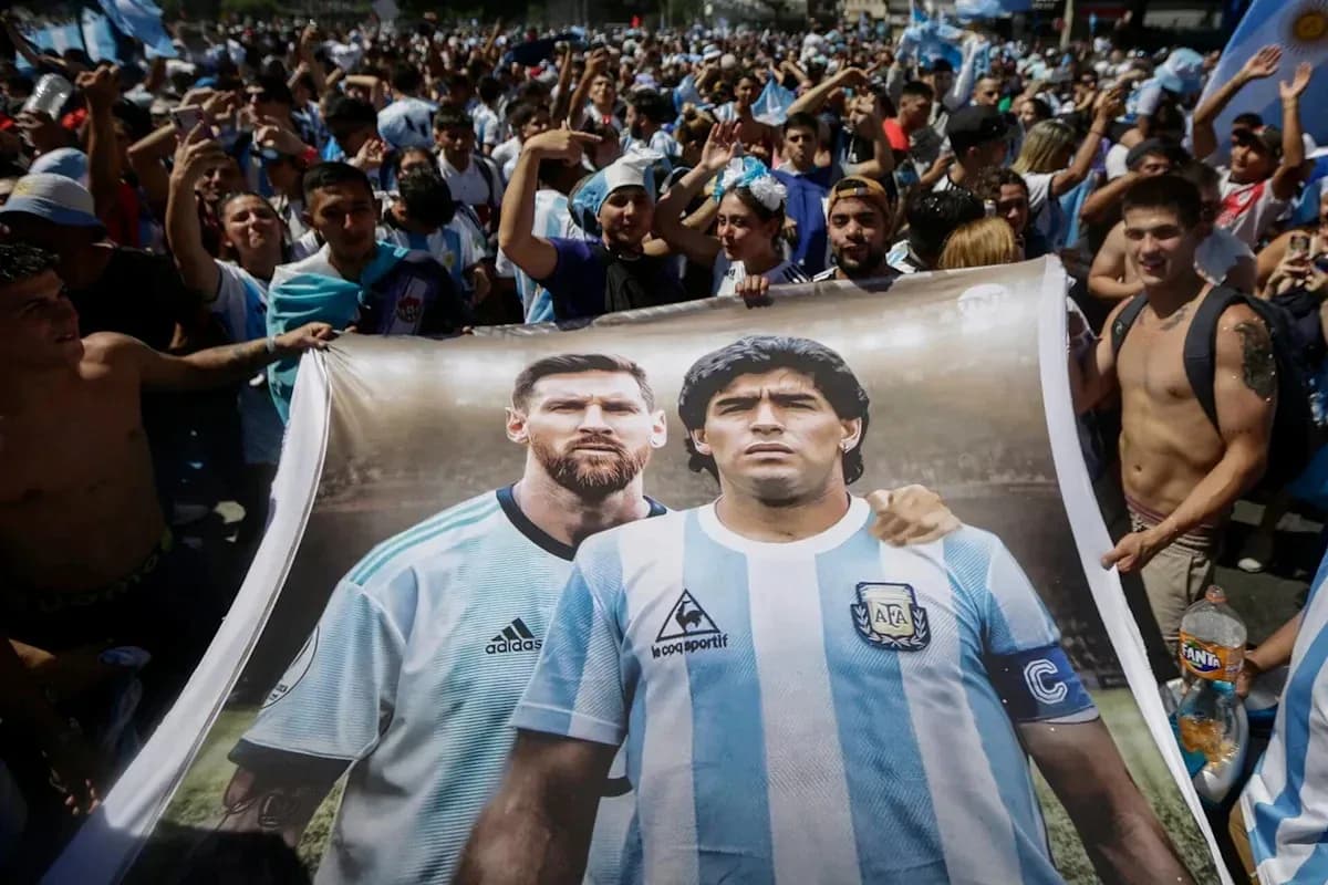 Fans holding a banner of Messi and Maradona Fans holding a banner of Messi and Maradona