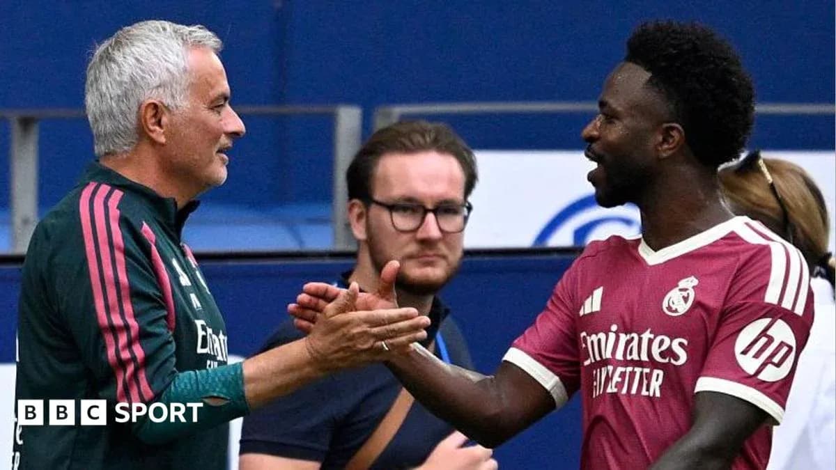 Two men shaking hands on football pitch Two men shaking hands on football pitch