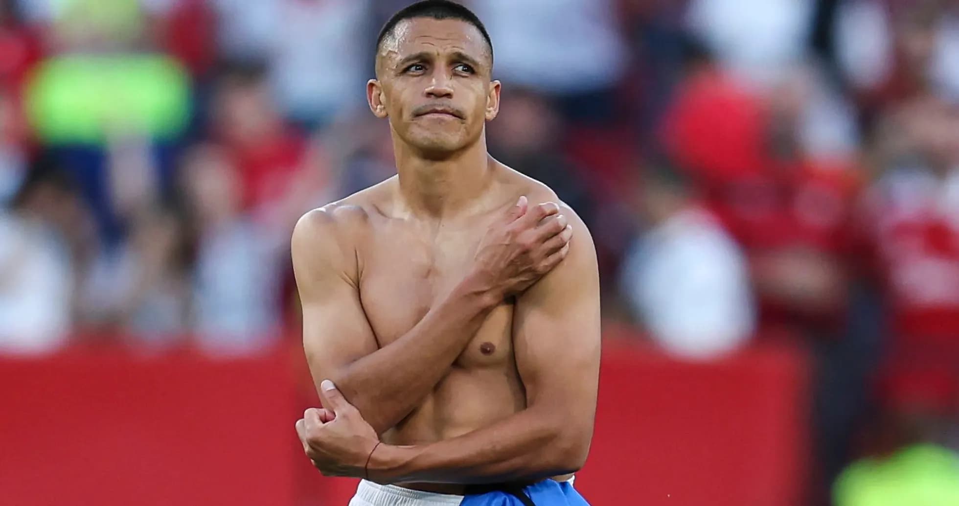 Football player with bare torso on field Football player with bare torso on field