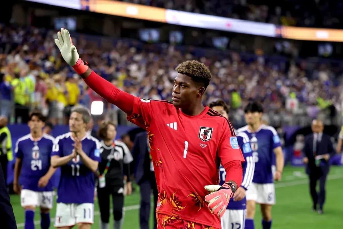 Goalkeeper in red jersey waving to fans Goalkeeper in red jersey waving to fans