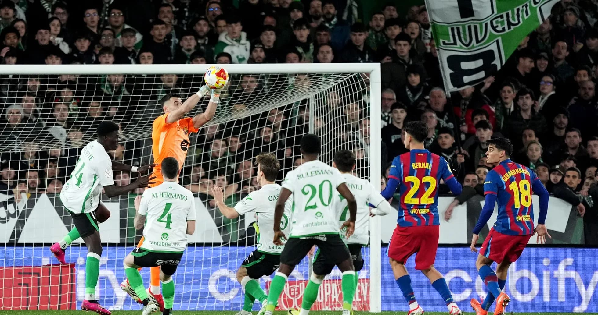Goalkeeper catching ball during intense football match Goalkeeper catching ball during intense football match