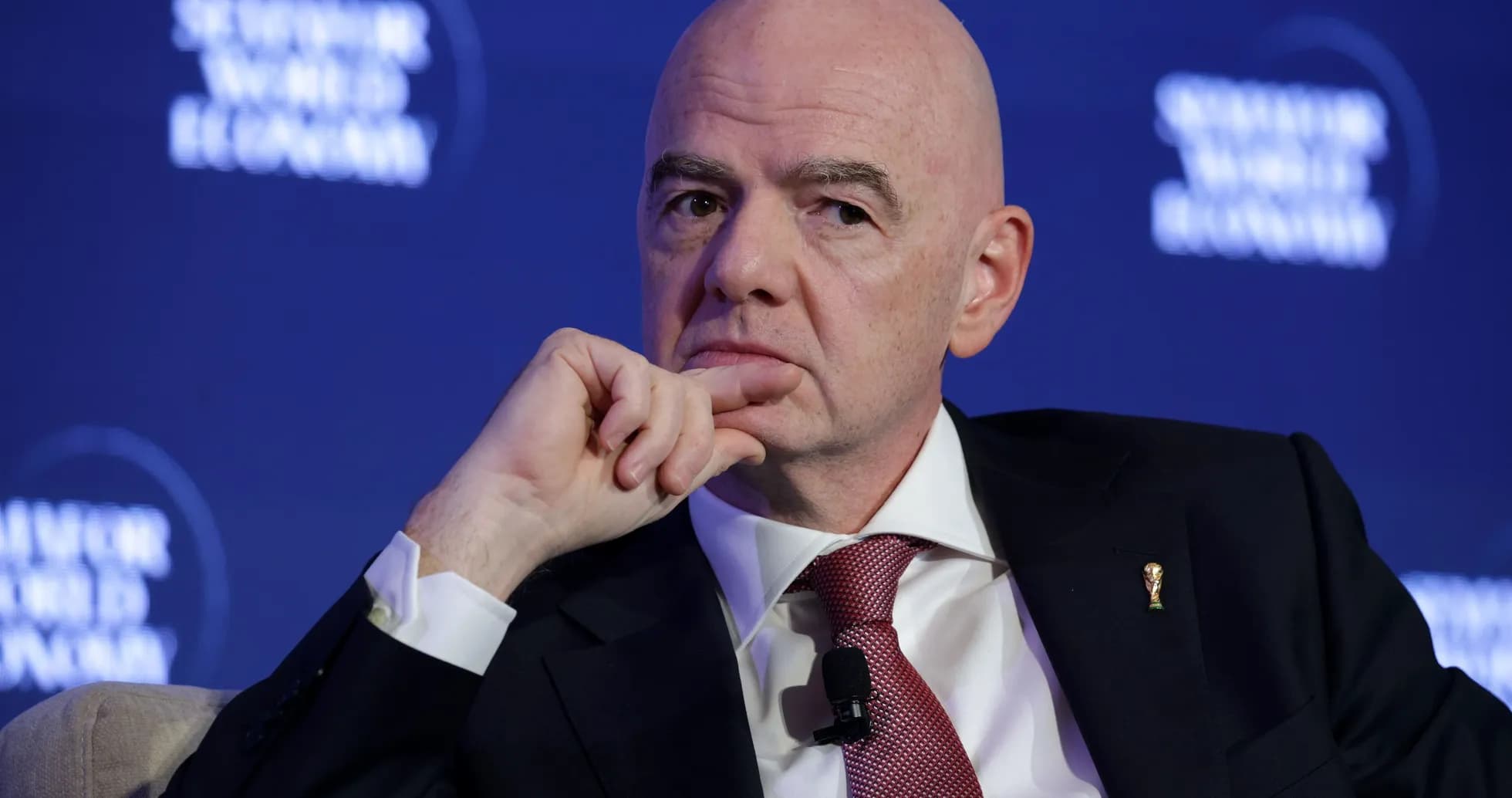 Man speaking at a conference with a thoughtful expression Man speaking at a conference with a thoughtful expression