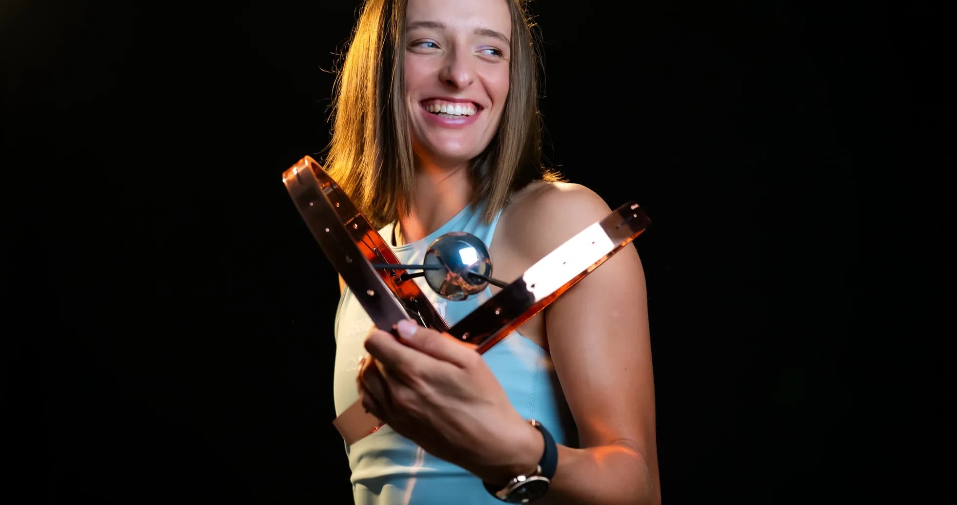 Athlete holding a trophy and smiling brightly Athlete holding a trophy and smiling brightly