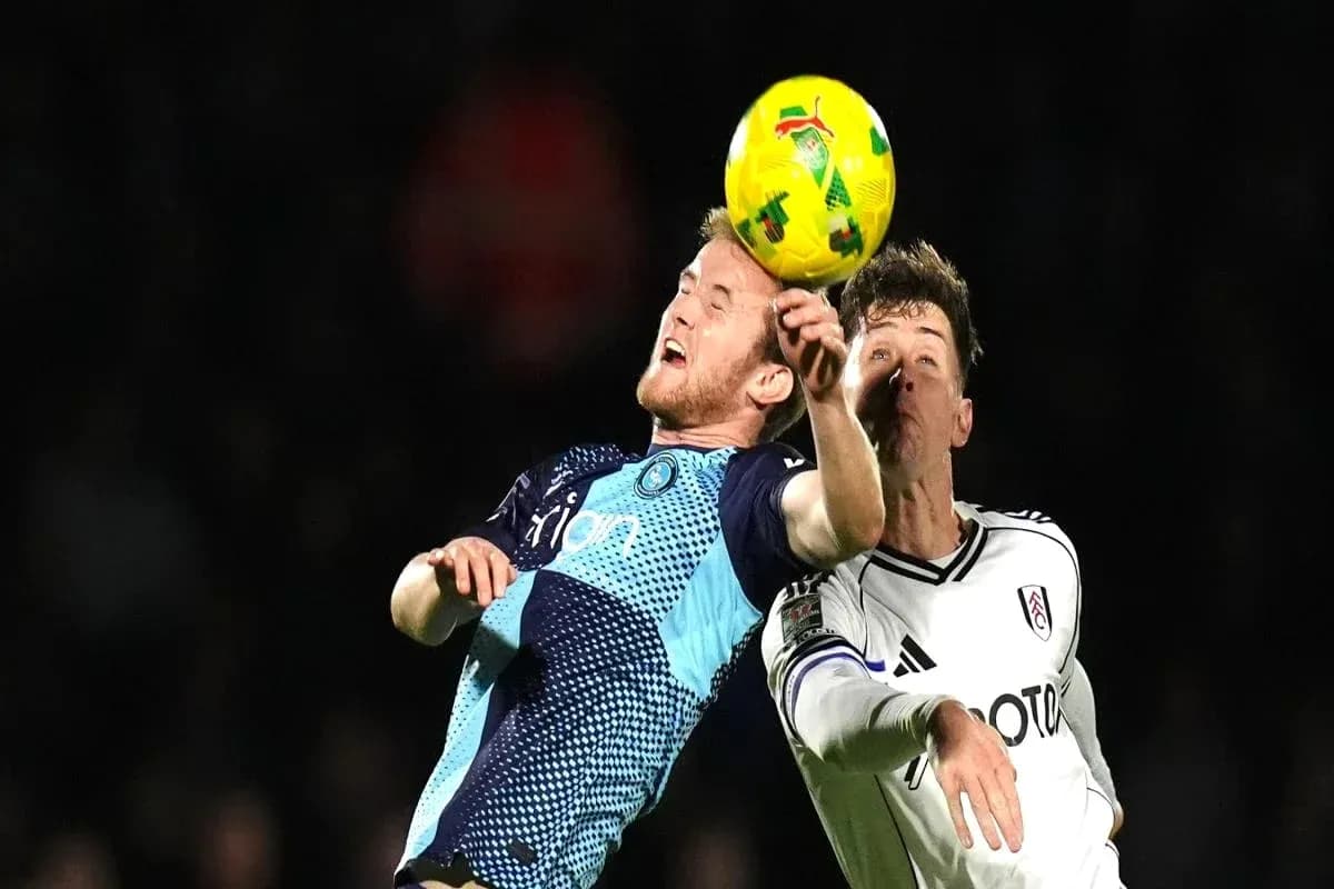Players contesting a header during football match Players contesting a header during football match
