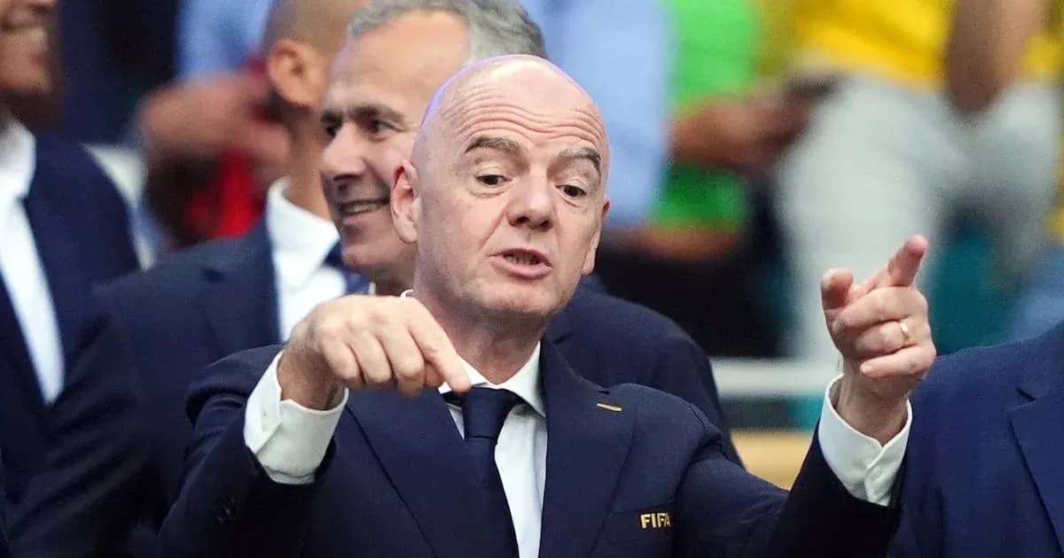 FIFA official speaking at event with audience behind FIFA official speaking at event with audience behind
