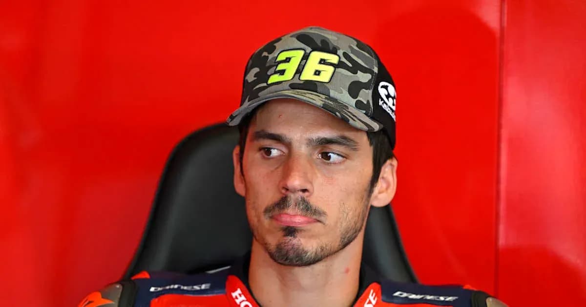 Motorsport athlete in team gear sitting in garage Motorsport athlete in team gear sitting in garage