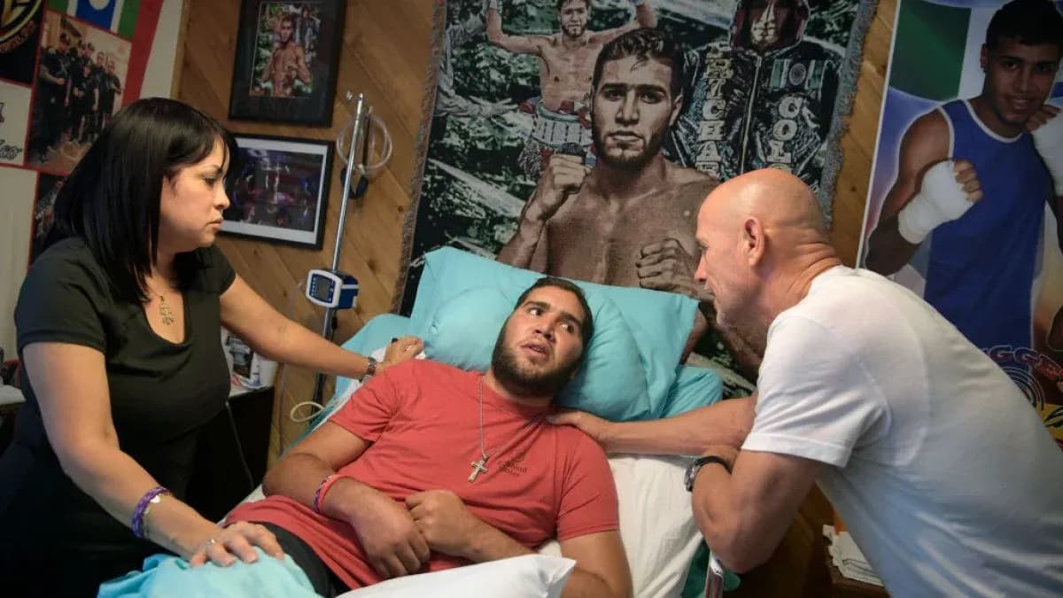 Man in bed with two people discussing health Man in bed with two people discussing health