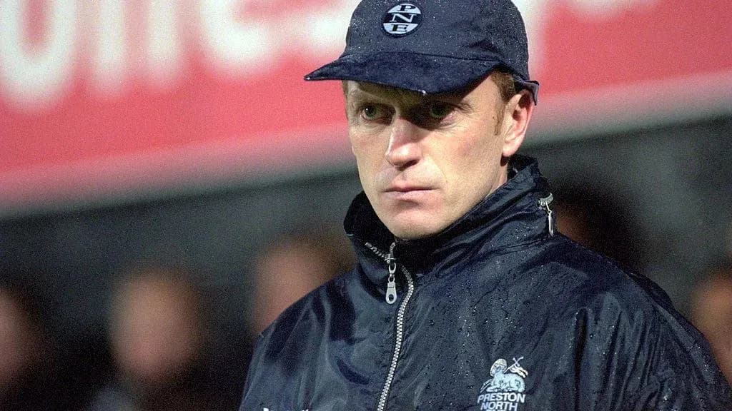 Preston North End manager during a rainy match Preston North End manager during a rainy match