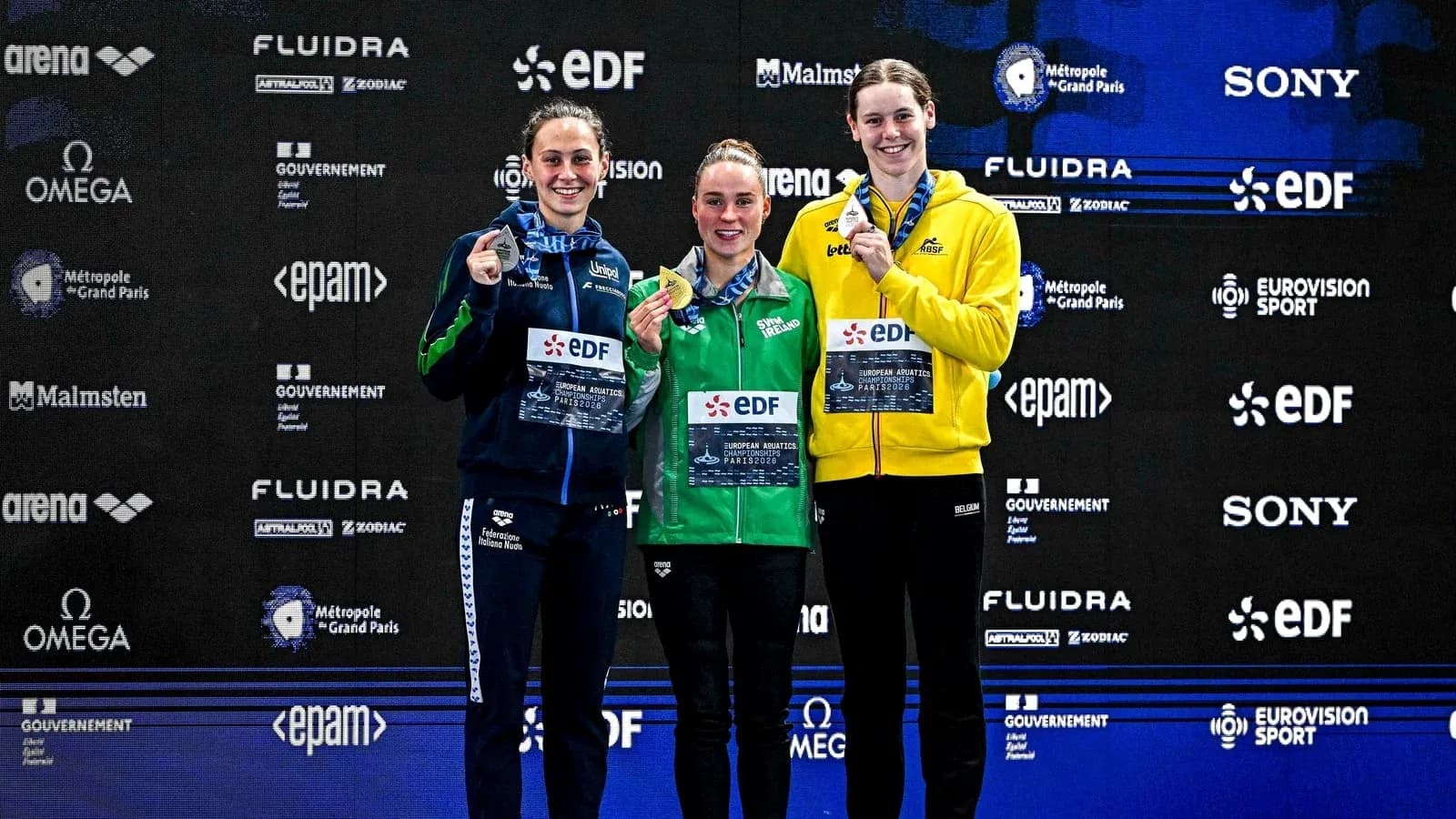Three swimmers on podium with medals at championship Three swimmers on podium with medals at championship