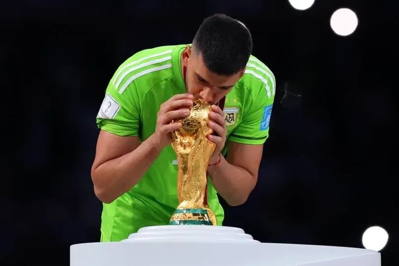 Goalkeeper kissing World Cup trophy on podium Goalkeeper kissing World Cup trophy on podium