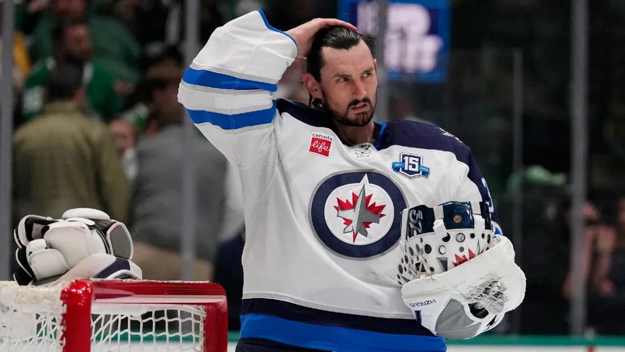 Hockey player in Winnipeg Jets jersey with helmet Hockey player in Winnipeg Jets jersey with helmet