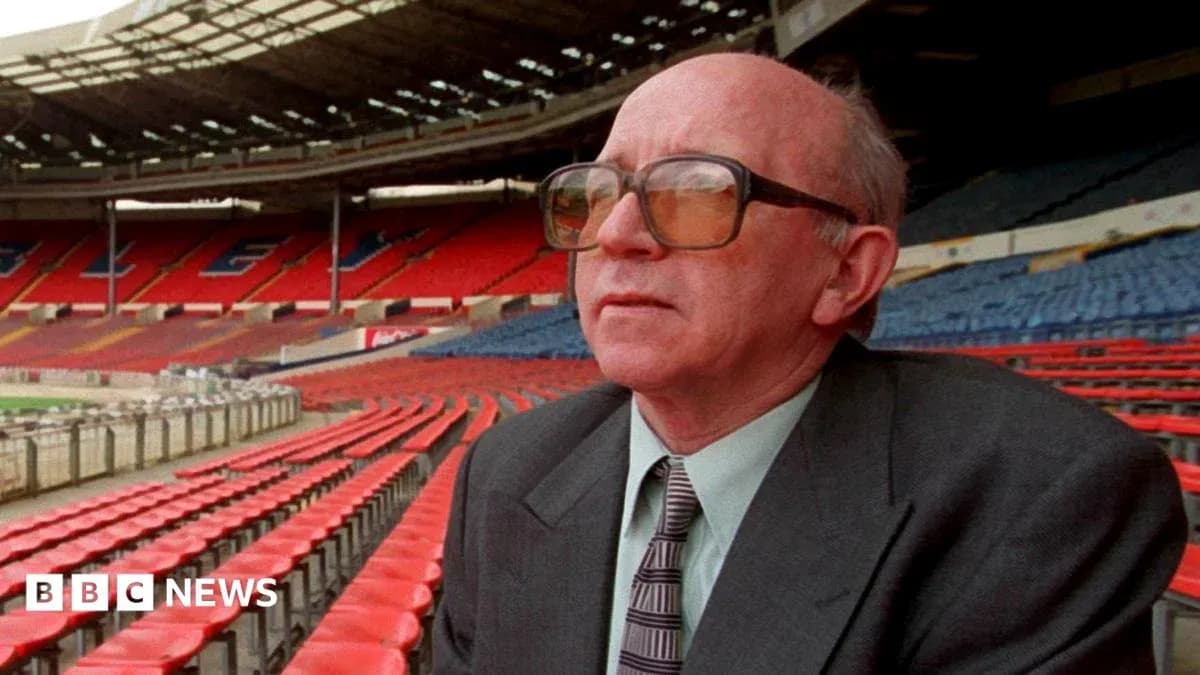 Man sitting in empty stadium with red seats Man sitting in empty stadium with red seats