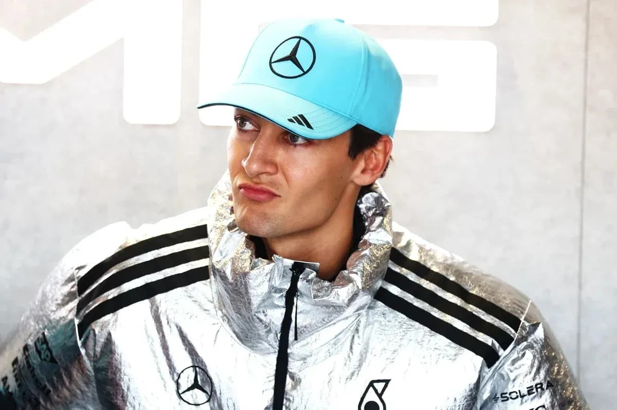 Yoshimura team member wearing silver jacket and cap Yoshimura team member wearing silver jacket and cap