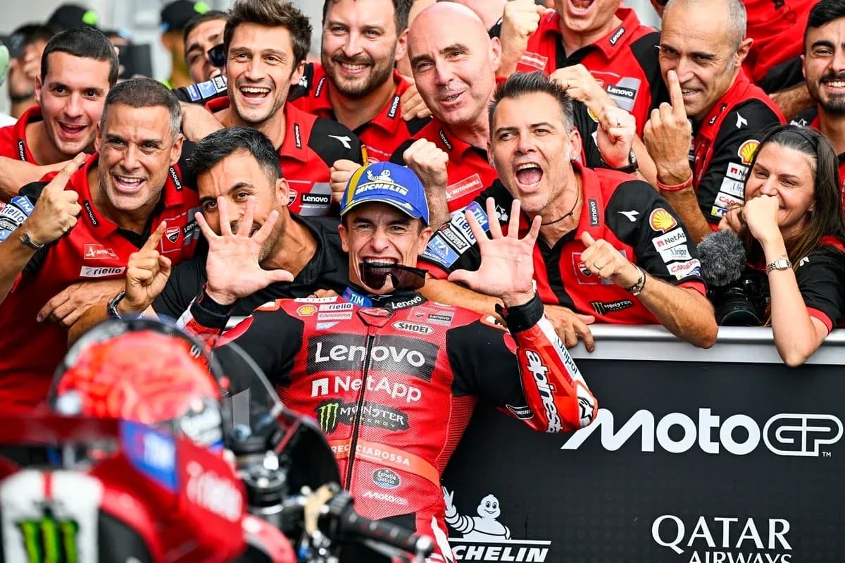 Ducati team celebrating victory with rider in pit Ducati team celebrating victory with rider in pit