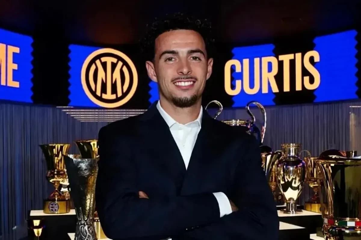 Man posing with trophies at Inter Milan event Man posing with trophies at Inter Milan event