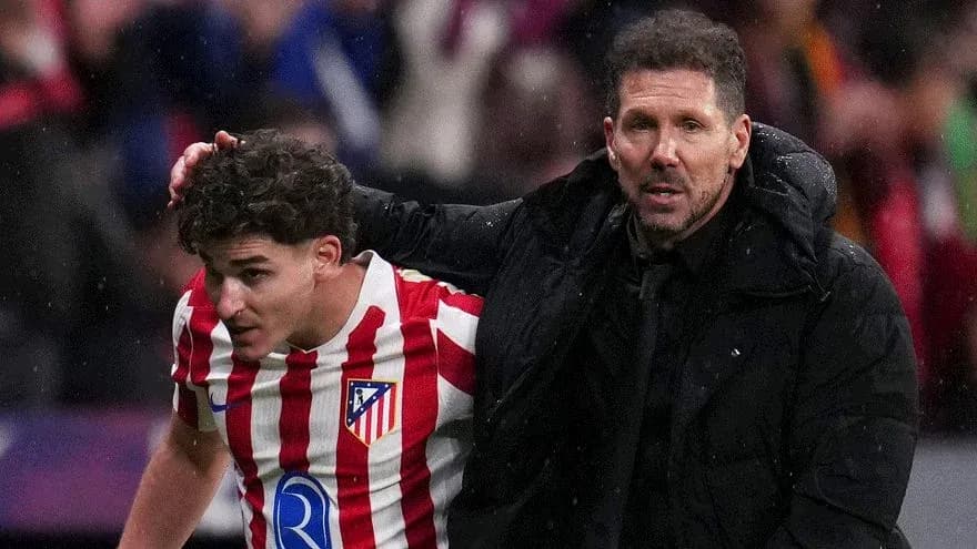 Atletico Madrid coach assisting player off field Atletico Madrid coach assisting player off field