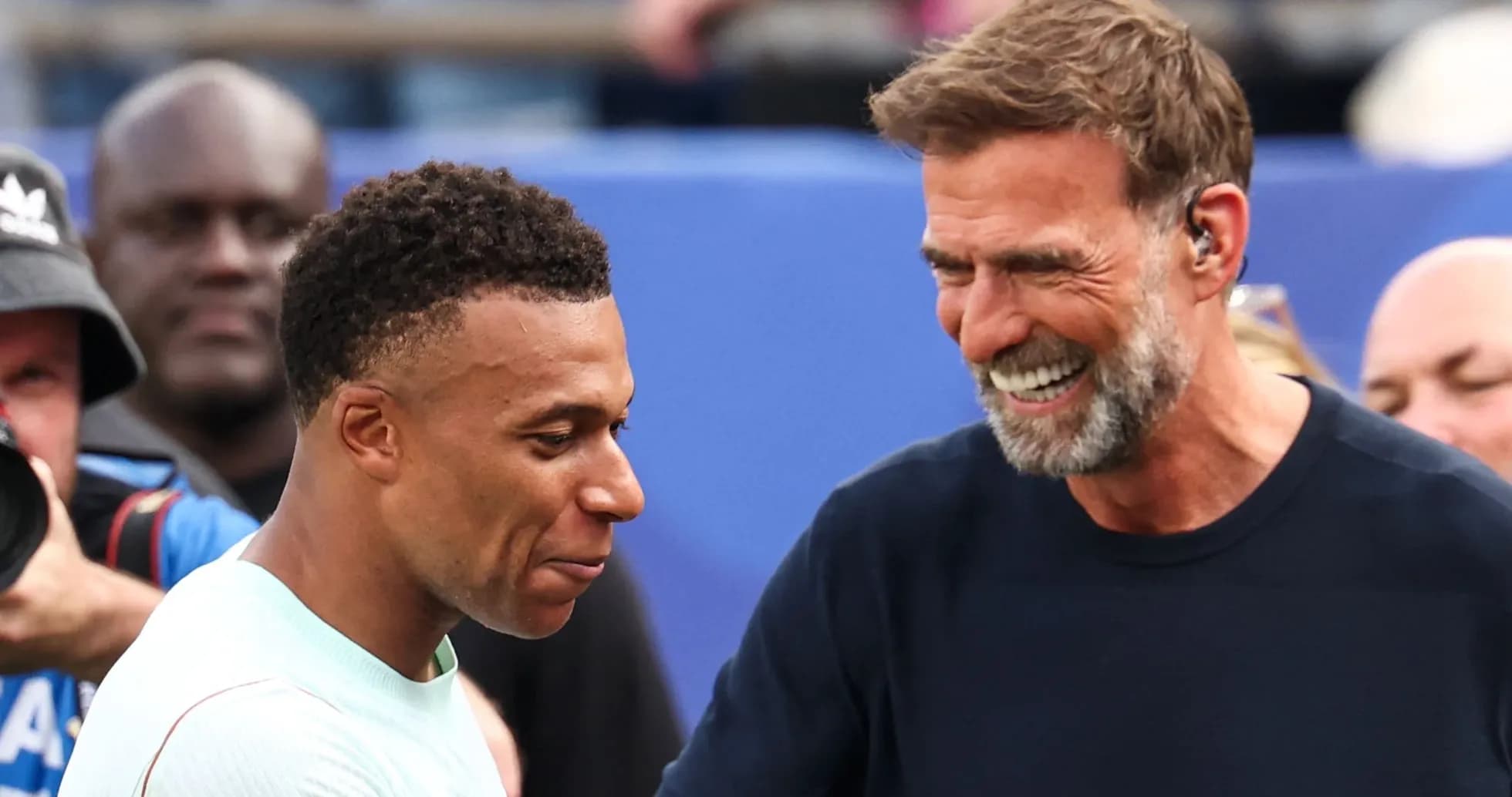 Kylian Mbappé and coach smiling during event Kylian Mbappé and coach smiling during event