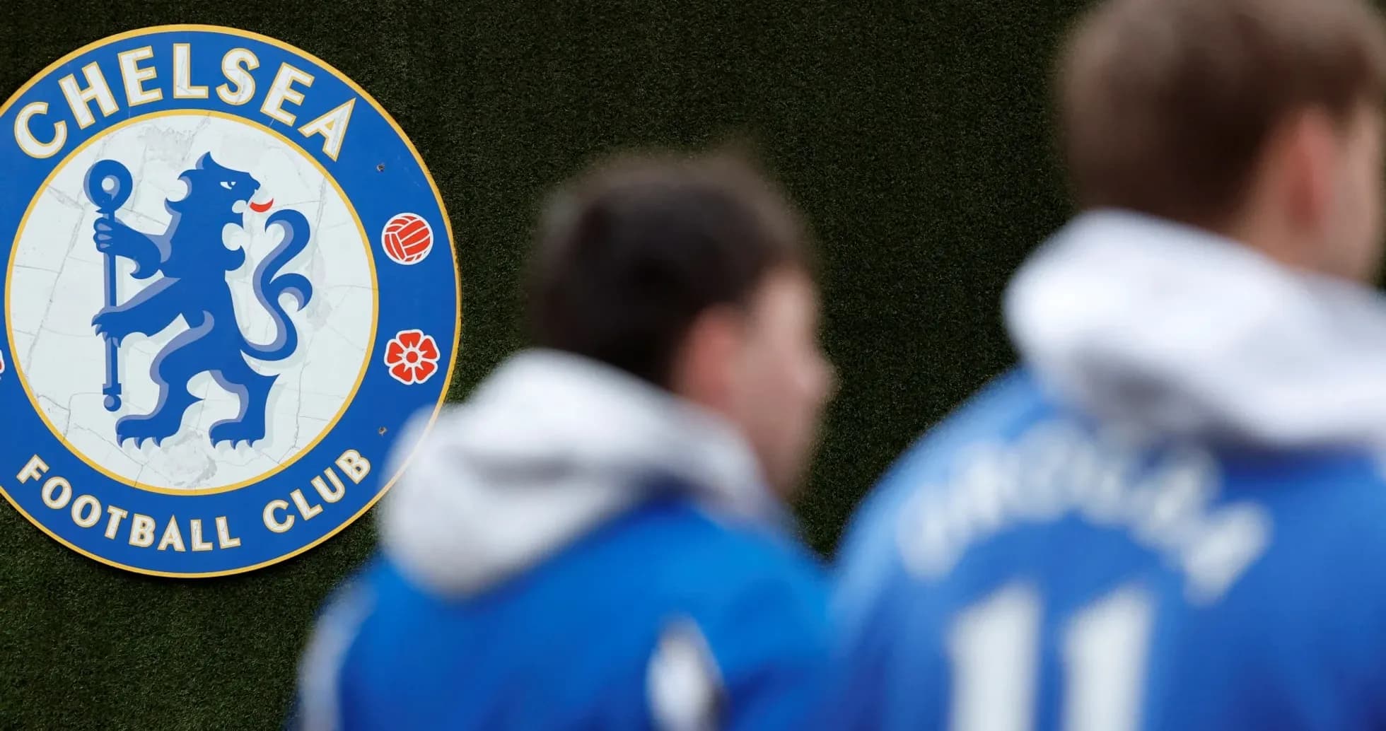 Chelsea FC emblem with players in training gear Chelsea FC emblem with players in training gear