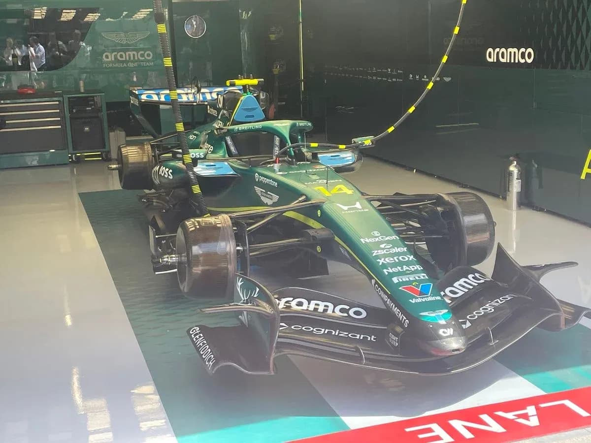 Aston Martin Formula 1 car in team garage Aston Martin Formula 1 car in team garage