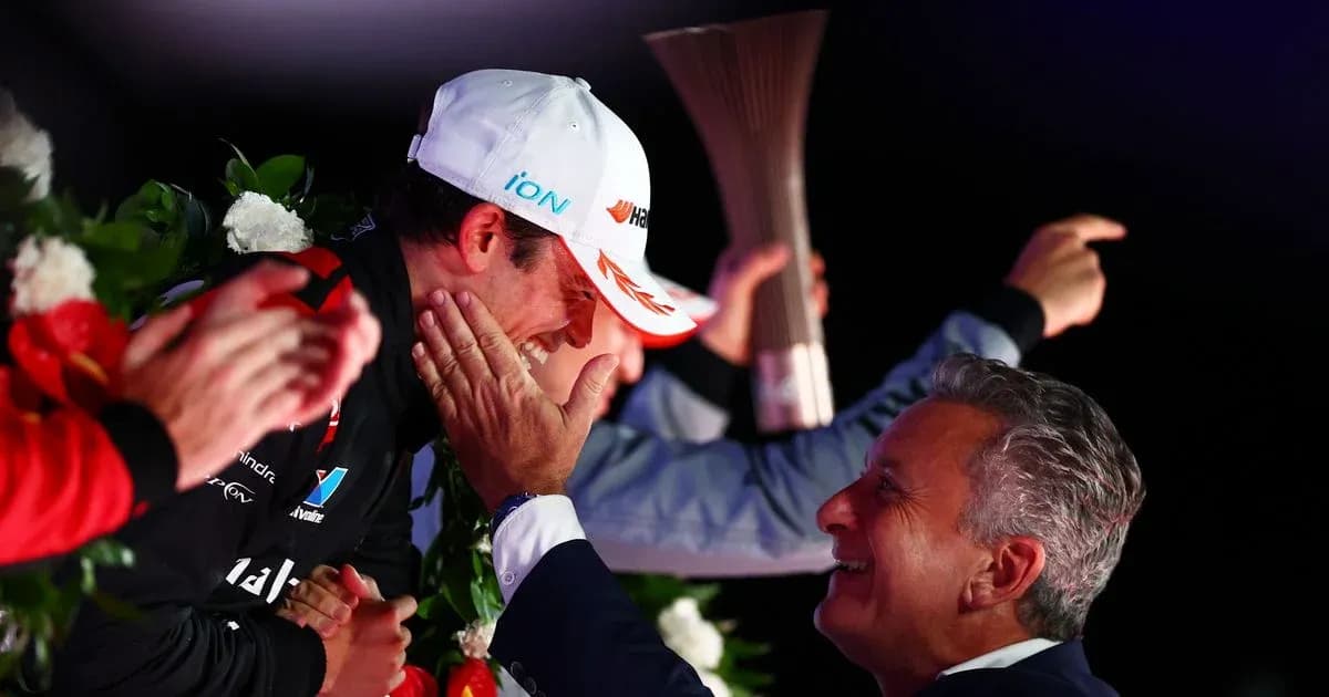 Driver celebrating with team member on podium Driver celebrating with team member on podium